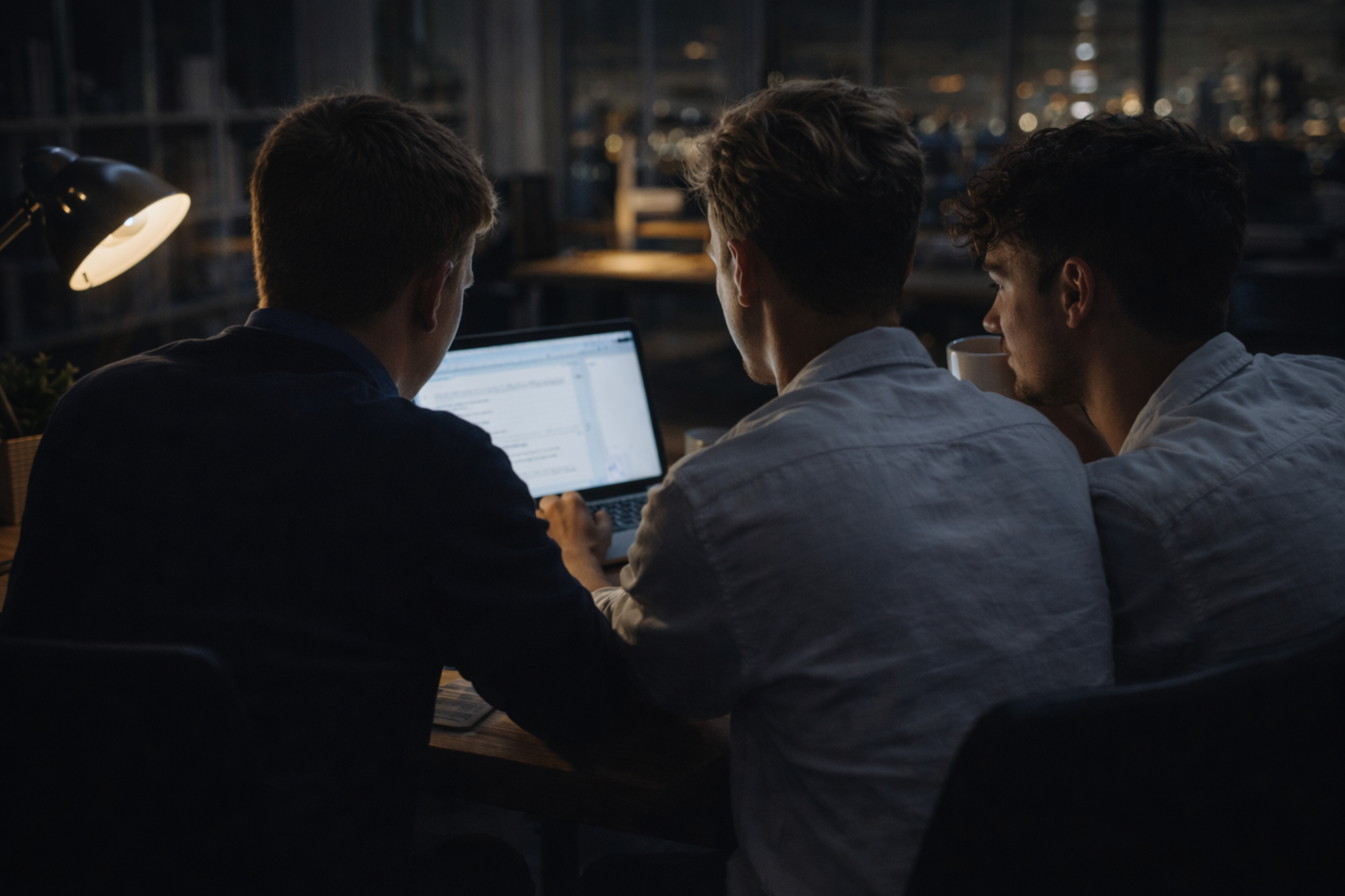 SVN members working together on a laptop in a late-evening study session