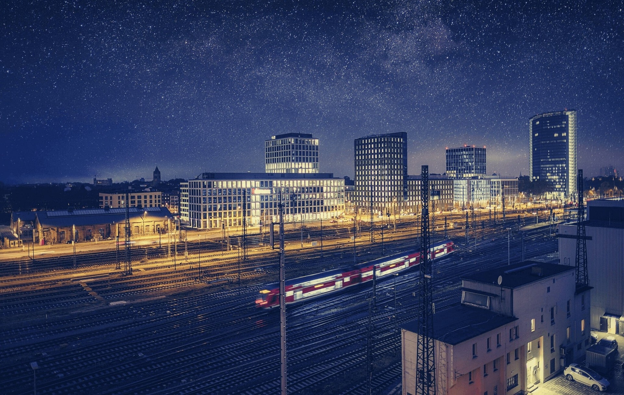 Night skyline of Mannheim with rail tracks and modern buildings